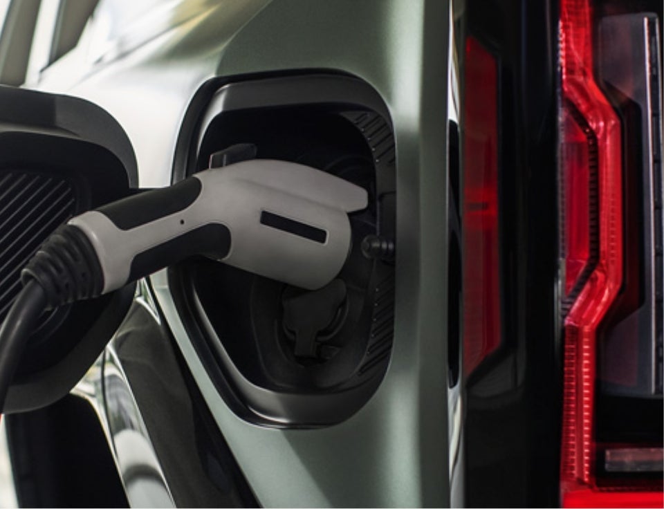Close up of charging port with charger plugged in on a GMC Hummer EV SUV - Randy Bowen GMC in CHANDLER OK